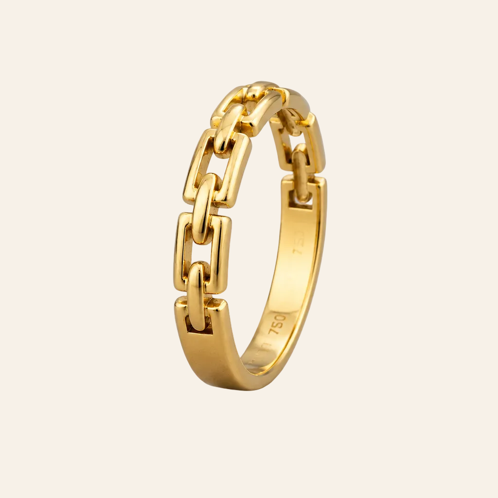 A polished yellow gold ring with a modern geometric link design, standing upright on a neutral light gray background.